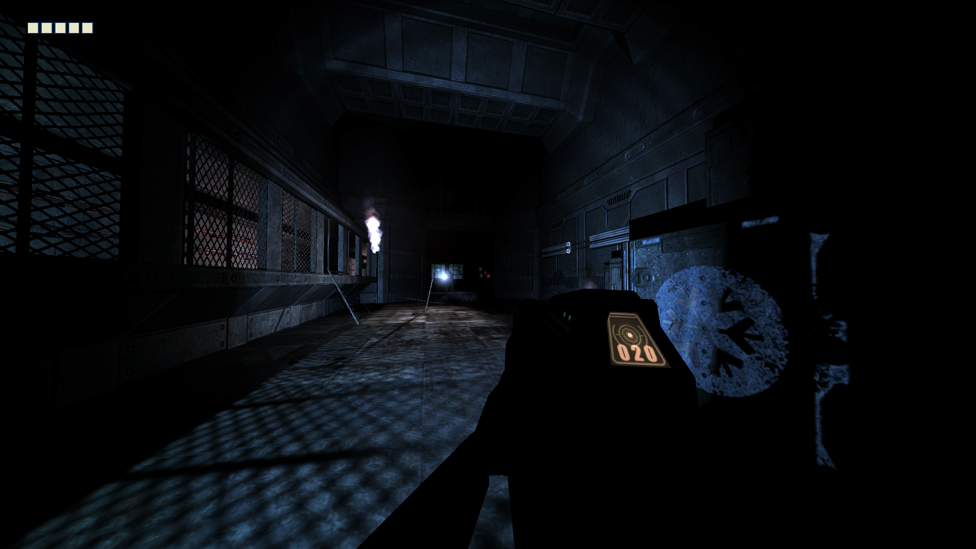 First person view, showing Riddick's hands holding a gun with a digital ammo display on the back shining a flashlight into a metal hallway. The guns silhouette is completely black, fully in shadow.