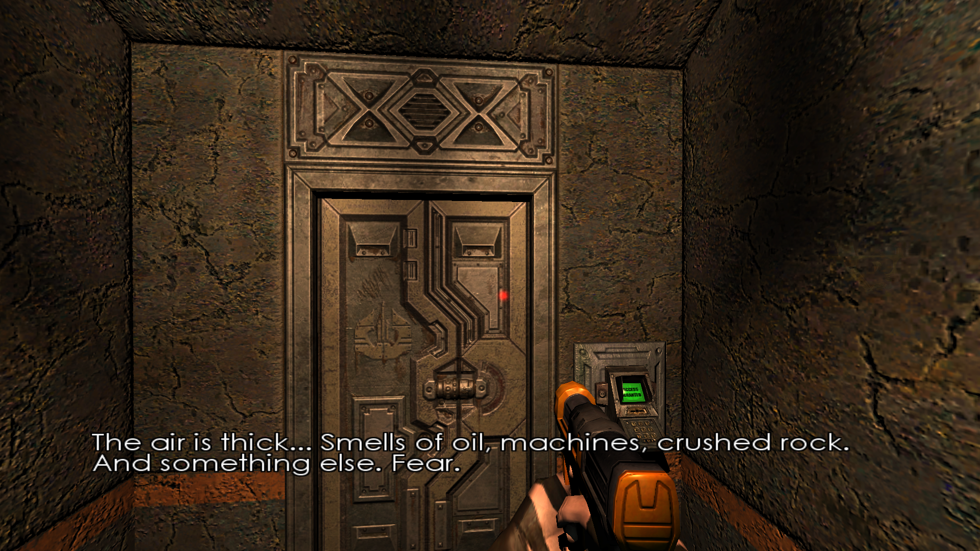 First person view of a closed metal door, with a subtitle on screen that reads 'The air is thick... Smells of oil, machines, crushed rock. And something else. Fear.'